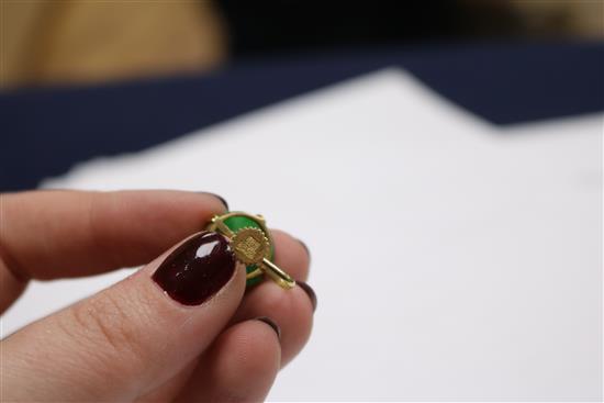 A pair of yellow metal and jade ear clips and a simulated jade pendant.